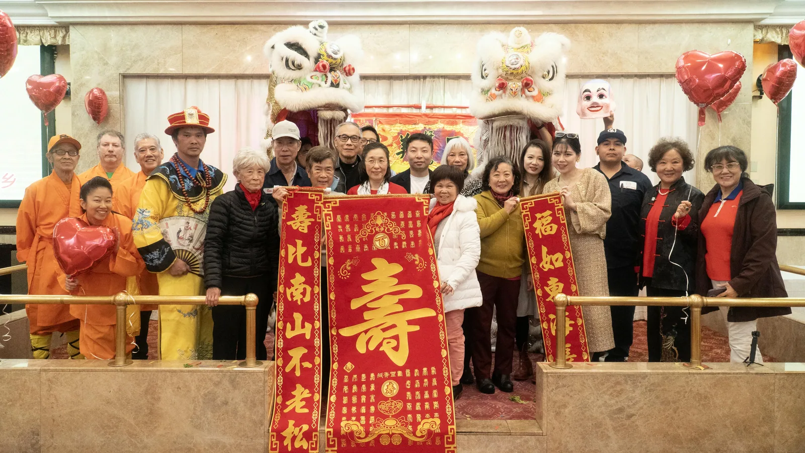 節慶活動大合照:住戶與來賓和舞獅表演者展示賀軸