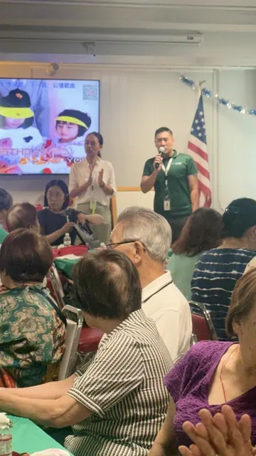 講者手持麥克風在活動大廳為住戶講解