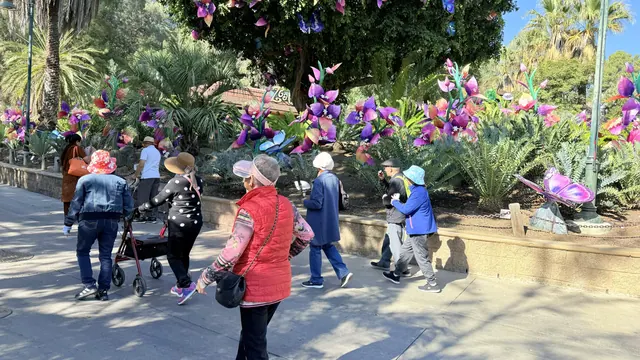 住戶漫步經過花卉與蝴蝶燈飾區
